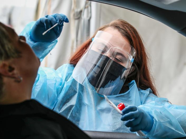 Hannah Finch takes nasal samples at the COVID testing facility at Churchill Downs on Friday, January 14, 2022