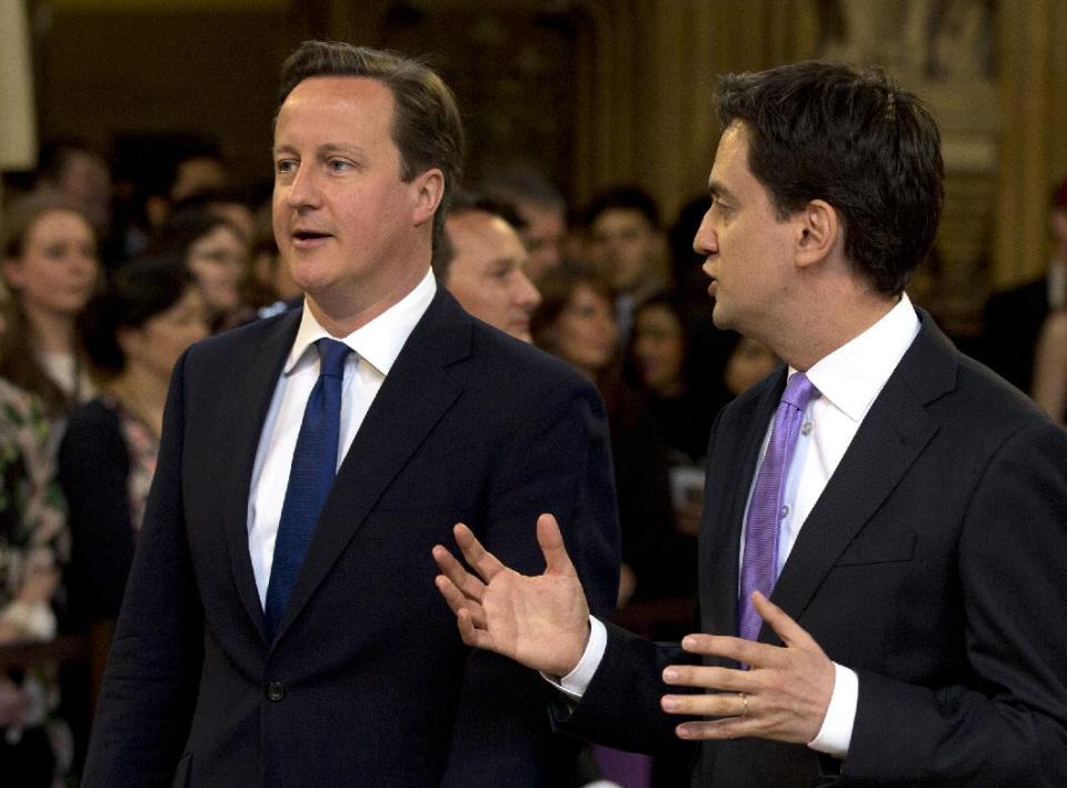 Britain's Prime Minister David Cameron, left, with the Leader of the Opposition Ed Milliband walk from the House of Commons through the central lobby towards the House of Lords to hear Britain's Queen Elizabeth II deliver the Queen's Speech to Parliament at the Place of Westminster in London Wednesday, May 8, 2013. The Queen's Speech outlines her governments legislative plans for the forthcoming parliamentary year, that her lawmakers will debate vote and enact on.(AP Photo/Alastair Grant, Pool)