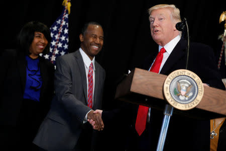 U.S. President Donald Trump (R) shakes hands with Ben Carson, his nominee to lead the Department of Housing and Urban Development (HUD), after their visit to the National Museum of African American History and Culture on the National Mall in Washington, U.S., February 21, 2017. Also pictured is Carson's wife, Candy Carson (L). REUTERS/Jonathan Ernst