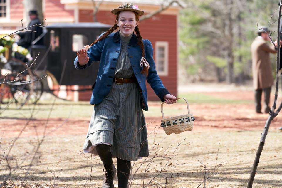 a character skipping down the street with a basket in hand