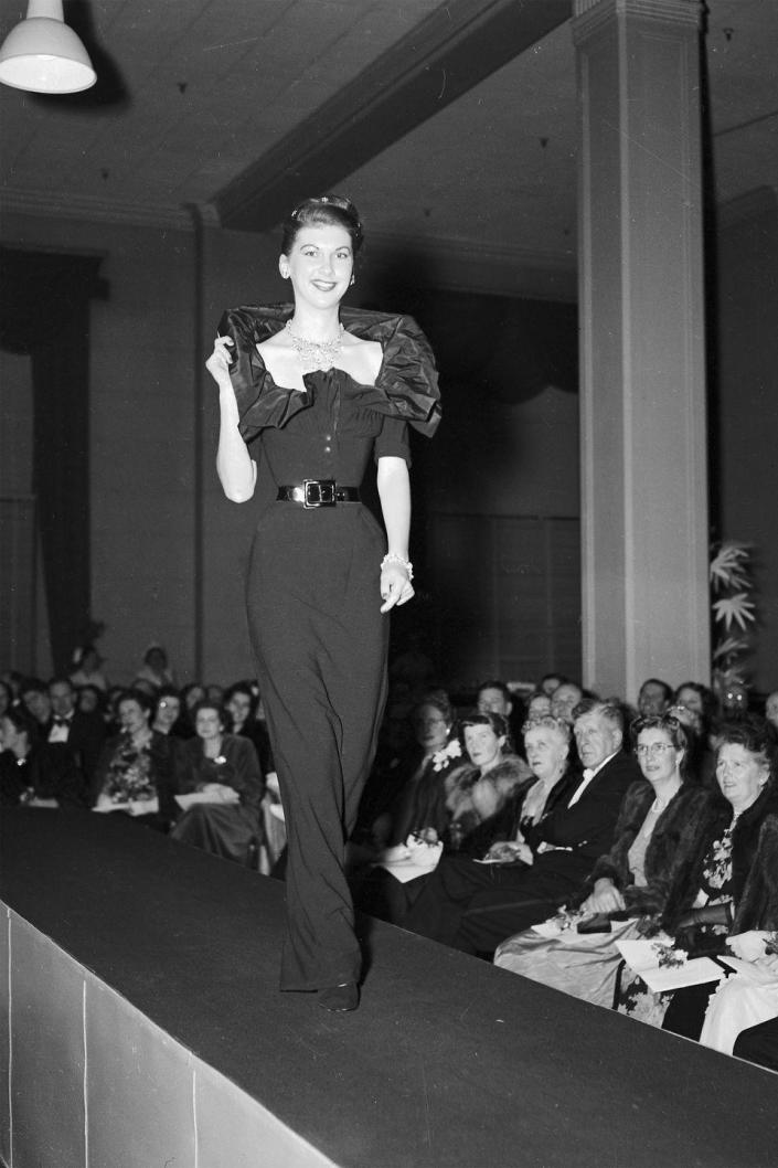 <p>A model walks the Christian Dior catwalk wearing a belted evening gown. </p>