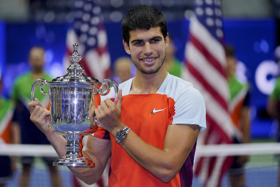 FILE - Carlos Alcaraz, of Spain, holds up the championship trophy after defeating Casper Ruud, of Norway, in the men's singles final of the U.S. Open tennis championships, Sunday, Sept. 11, 2022, in New York. Total prize money and player compensation at this year’s U.S. Open tennis tournament will reach a record $65 million, the U.S. Tennis Association said Tuesday, Aug. 8, 2023, noting that number is boosted by increases in the amount of expenses covered.(AP Photo/Charles Krupa, File)