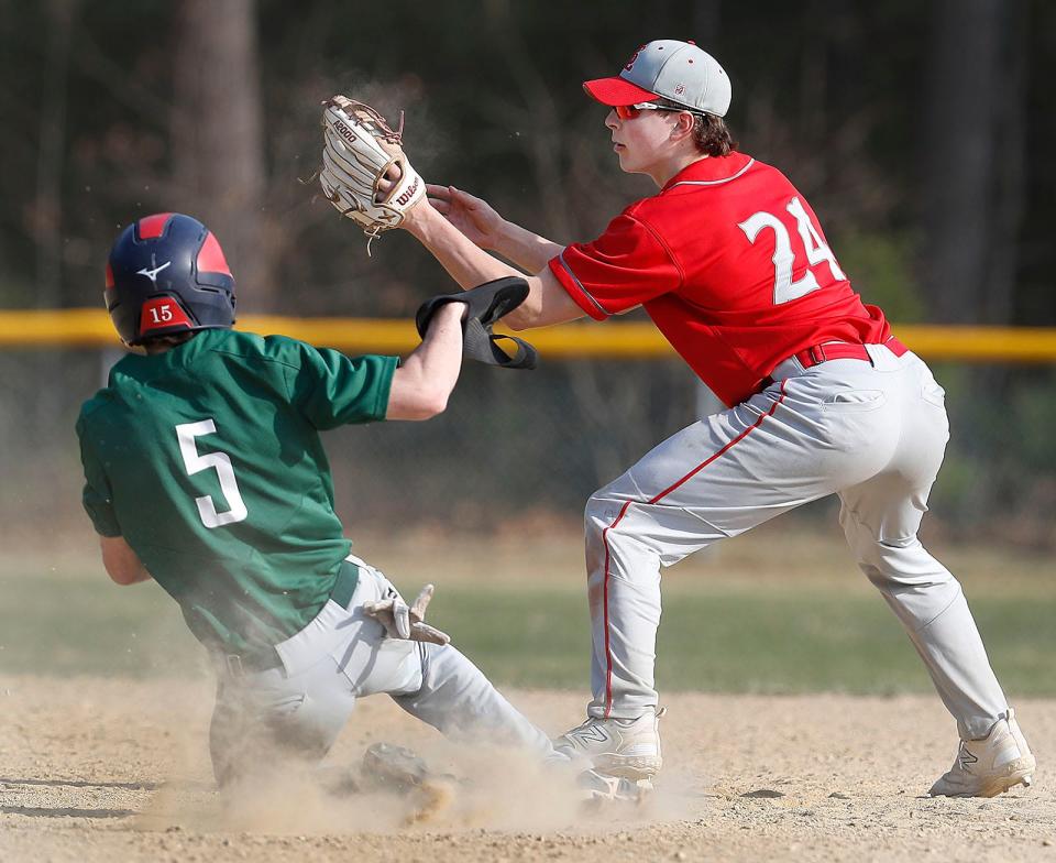 Dragon Mike Hocking slides under a late tag by SL infielder Connor Finn.Duxbury hosted Silver Lake High in baseball  on Friday April 14, 2023 