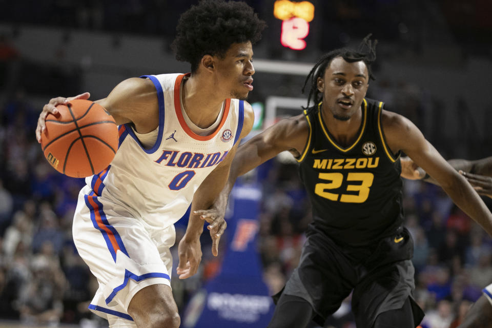 Florida guard Zyon Pullin (0) drives against Missouri forward Aidan Shaw (23) during the second half of an NCAA college basketball game Wednesday, Feb. 28, 2024, in Gainesville, Fla. (AP Photo/Alan Youngblood)