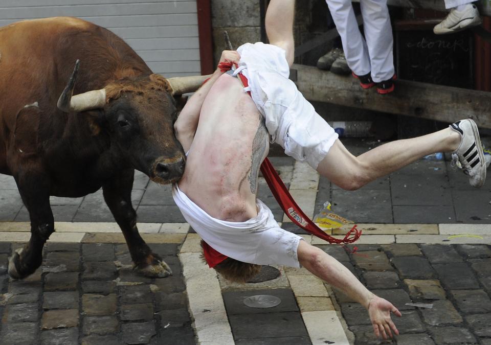 A&nbsp;bull charges at a participant during a bull run at the San Fermin Festival in Pamplona, Spain, on July 7.