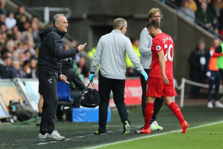 Liverpool's Adam Lallana leaves the pitch injured during their English Premier League match against Swansea City, at The Liberty Stadium in Swansea, south Wales, on October 1, 2016