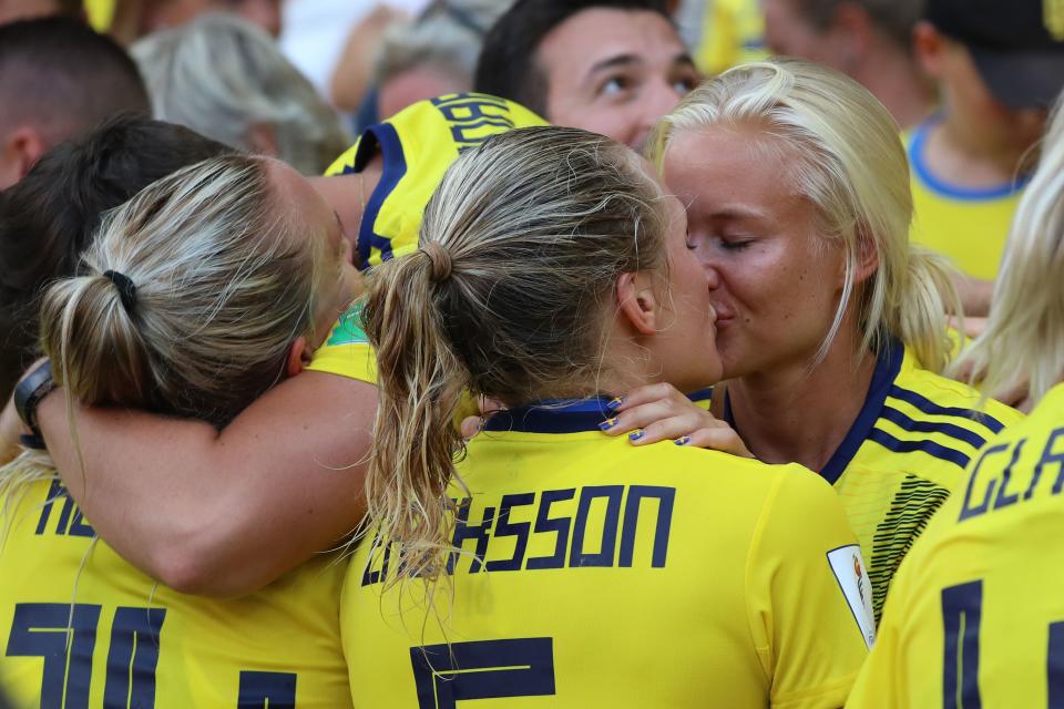 TOPSHOT - Sweden's defender Magdalena Eriksson (C) kisses her girlfriend Danish international Pernille Harder (R) as she celebrates her team's victory at the end of the France 2019 Women's World Cup third place final football match between England and Sweden, on July 6, 2019, at Nice stadium in Nice south-eastern France. (Photo by Valery HACHE / AFP)        (Photo credit should read VALERY HACHE/AFP/Getty Images)