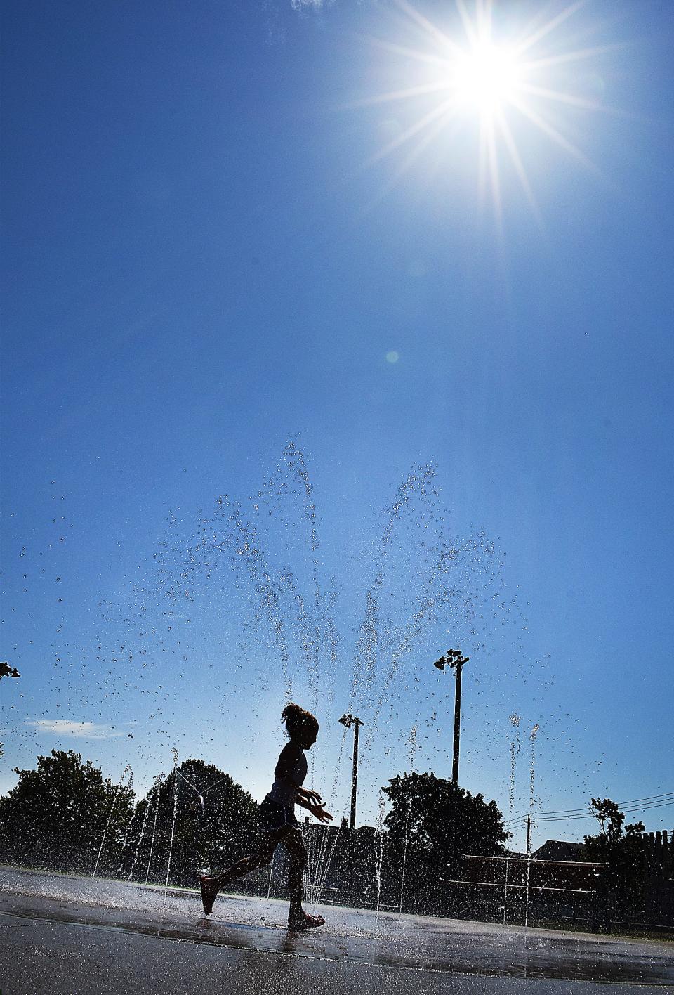 Helloa Fernandes plays at the Pulaski Park splash pad on Aug. 9, 2022. The splash pad was built using $69,500 of Community Preservation Act funds.