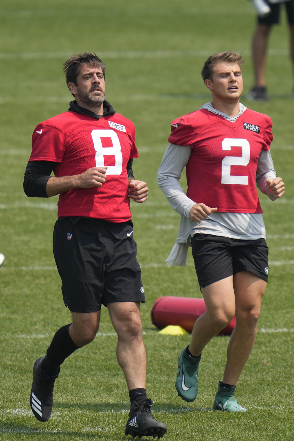 New York Jets quarterbacks Aaron Rodgers, left, and Zach Wilson warm-up at the NFL football team's training facility in Florham Park, N.J., Tuesday, June 6, 2023. (AP Photo/Seth Wenig)