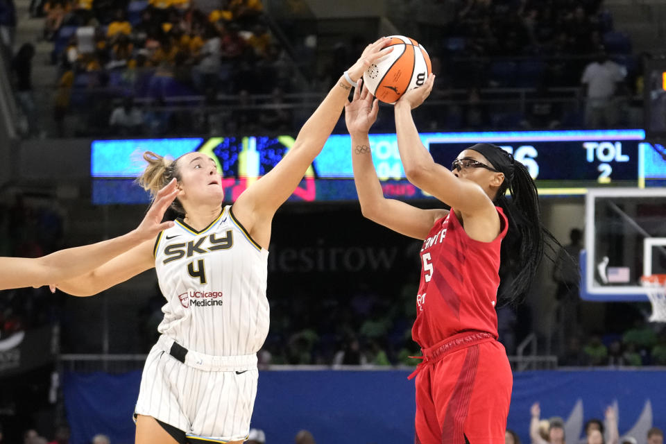 Chicago Sky's Marina Mabrey, left, blocks the shot of Atlanta Dream's Allisha Gray in the closing seconds of a WNBA basketball game Wednesday, July 10, 2024, in Chicago. The Sky won 78-69. (AP Photo/Charles Rex Arbogast)