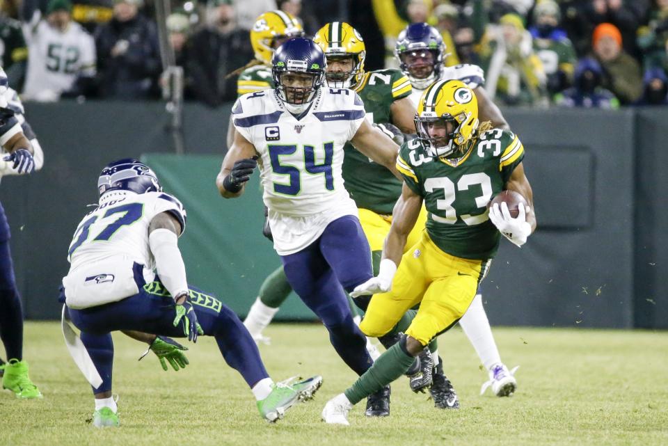 Green Bay Packers' Aaron Jones runs during the first half of an NFL divisional playoff football game against the Seattle Seahawks Sunday, Jan. 12, 2020, in Green Bay, Wis. (AP Photo/Mike Roemer)