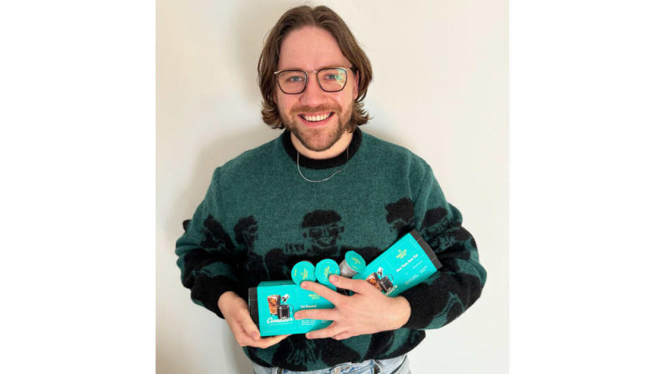 Coleman Spilde holds a package of Houseplant coffee