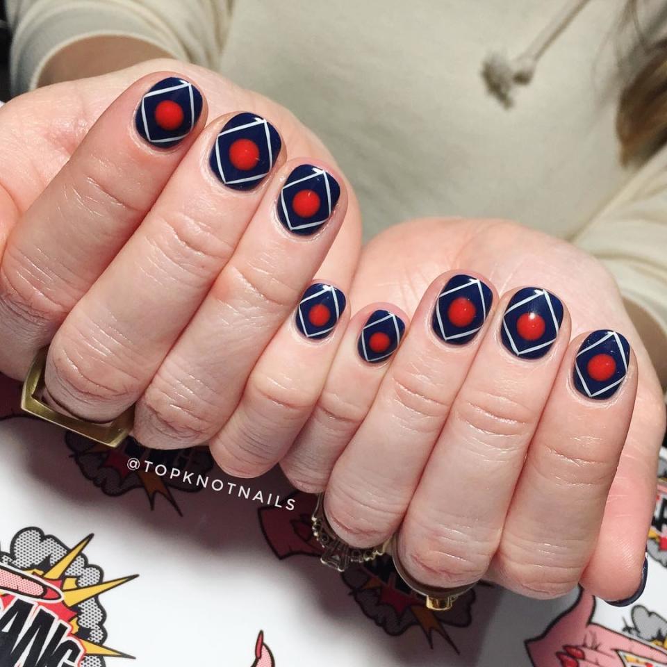 There's something subtly futuristic about this <a href="https://www.instagram.com/p/BuZL112jfEF/" rel="nofollow noopener" target="_blank" data-ylk="slk:manicure by Sarah Kane;elm:context_link;itc:0;sec:content-canvas" class="link ">manicure by Sarah Kane</a> (which has a navy base with skinny white diamond and a red dot in the middle), even though it was created with classic colors. As long as you have a steady hand, there's no need to visit a nail artist for this look — though we don't blame you if you do.