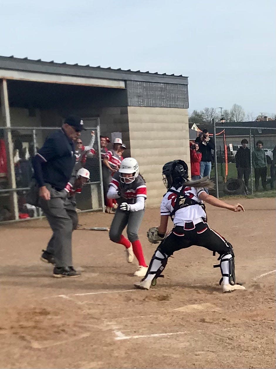 Cardington catcher Emalee Artz tags out a Fredericktown runner trying to score on a three from left fielder Dana Bertke during a softball game Thursday night at Fredericktown.