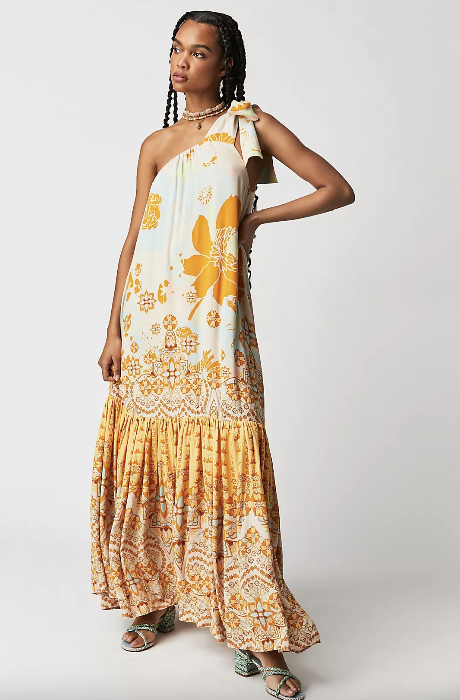 model wearing one sleeve yellow and white floral Cote D Azur Maxi Dress (photo via Free People)