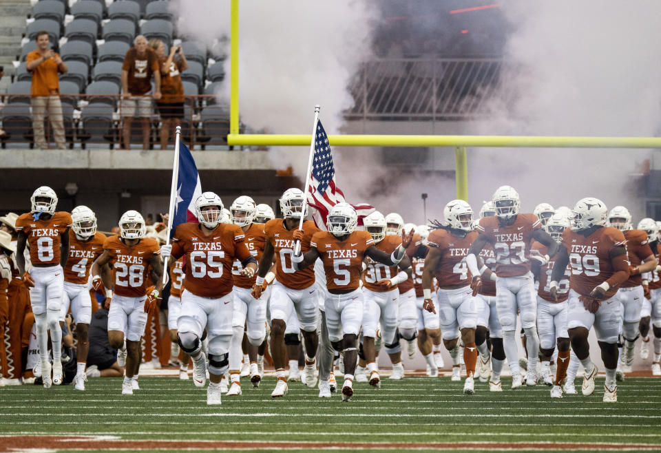 FILE - Texas players run onto the field before an NCAA college football game against Louisiana-Monroe, Saturday, Sept. 3, 2022, in Austin, Texas. Now with Texas set to join the Southeastern Conference, the Longhorn Network is set to quietly fold into the SEC network, shuttering a pioneering effort that briefly rocked not just the Big 12, but college football. (AP Photo/Michael Thomas, File)