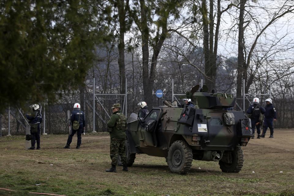 Greek Army and Police guard the border gate in Kastanies village as migrants try to enter Greece from the Pazarkule border gate, Edirne, Turkey, at the Greek-Turkish border Saturday, Feb. 29, 2020. Turkish President Recep Tayyip Erdogan said Saturday that his country's borders with Europe were open, as thousands of refugees gathered at the frontier with Greece. (AP Photo/Giannis Papanikos)