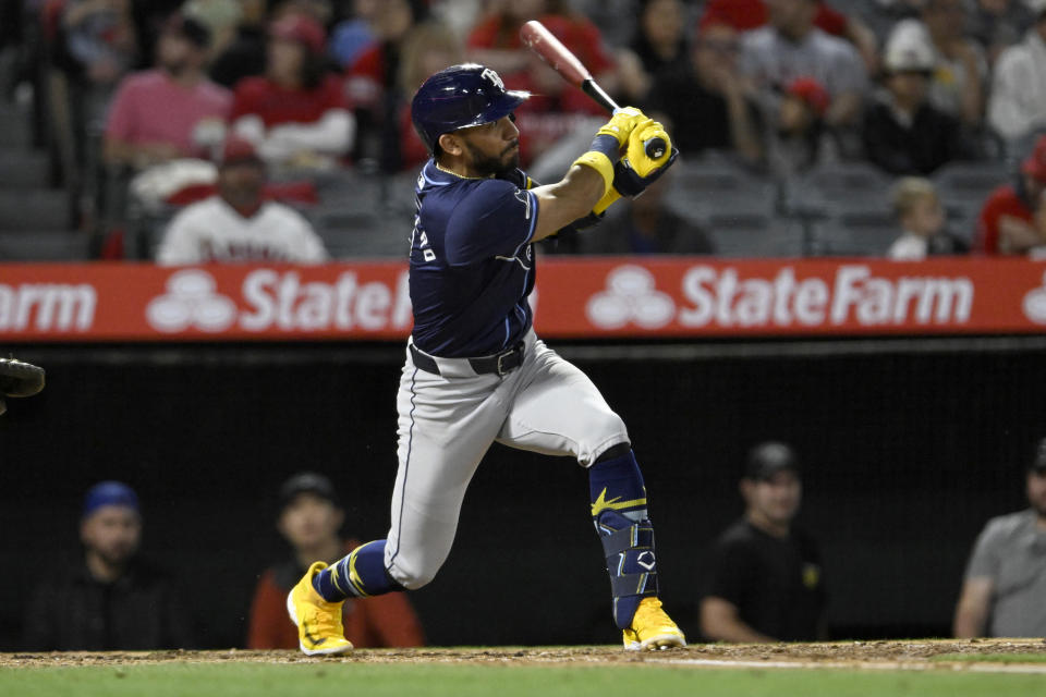 Tampa Bay Rays' Jose Caballero watches his RBI double against the Los Angeles Angels during the fourth inning of a baseball game in Anaheim, Calif., Tuesday, April 9, 2024. (AP Photo/Alex Gallardo)