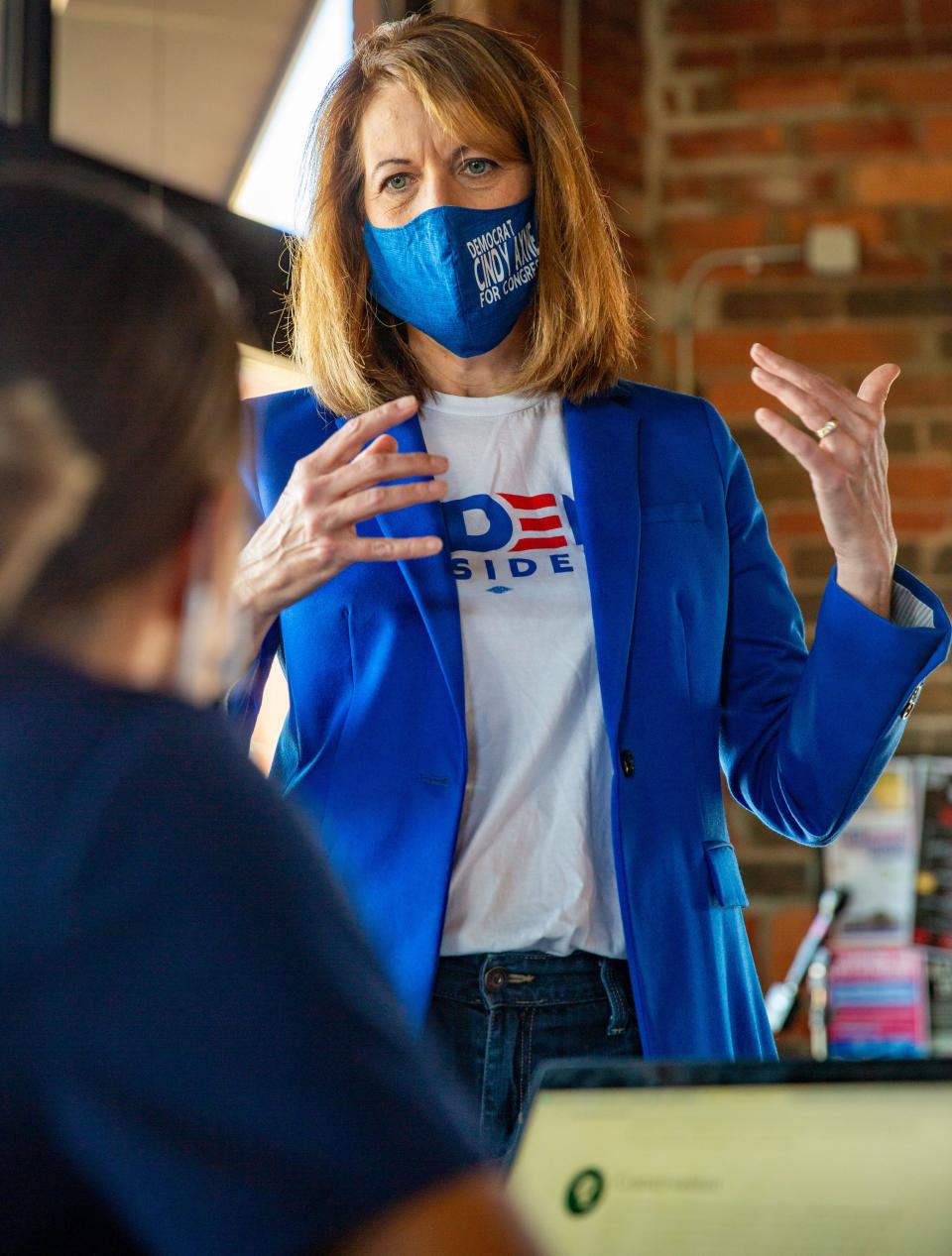 U.S. Representative Cindy Axne (D-IA) talks with voters at Smokey Row Coffee in Des Moines, Iowa, Tuesday, Nov. 3, 2020.