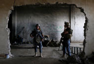 <p>Members of Iraqi Federal Police stand guard at a factory used by Islamic State militants to manufacture home made mortars in western Mosul, Iraq, May 11, 2017. (Photo: Danish Siddiqui/Reuters) </p>