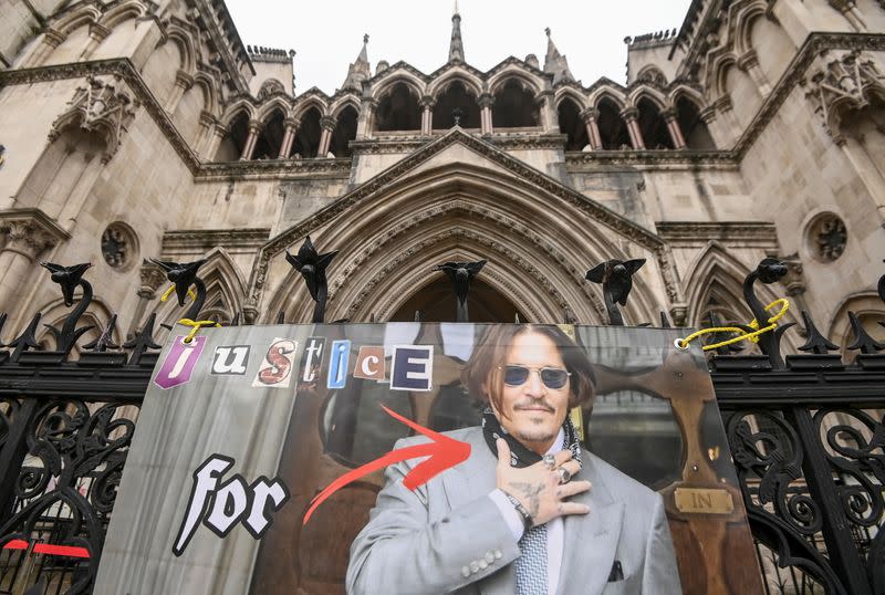 Poster placed by a supporter of actor Johnny Depp is seen at the High Court in London