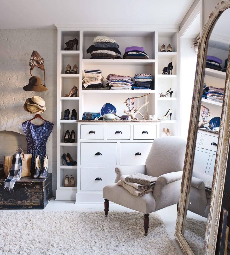 deary built the shelves in the dressing room the rug is by shaw floors and the linen upholstered chair is by john derian