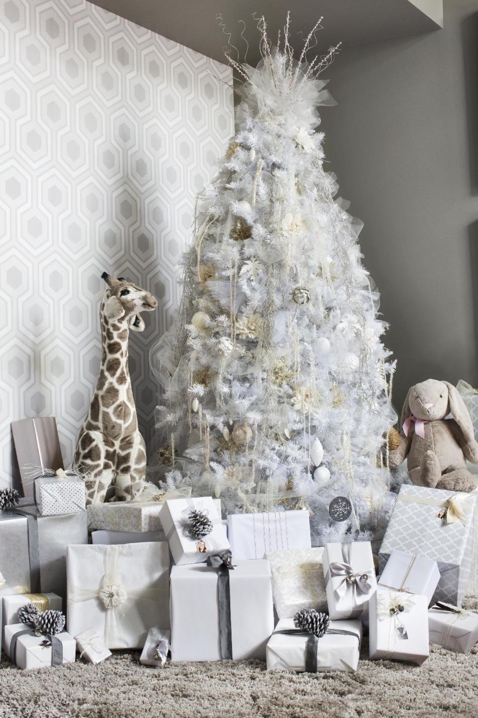 In this photo provided by Brian Patrick Flynn, for a creative twist on a traditional Christmas tree, the designer Flynn for HGTV.com uses a muted color palette of white, cream, gray and tan for a fresh look that's understated and elegant. (AP Photo/Brian Patrick Flynn, HGTV.com Holiday House)