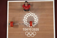 Akbar Djuraev of Uzbekistan celebrates after winning the gold medal and set a new olympic record in the men's 109kg weightlifting event, at the 2020 Summer Olympics, Tuesday, Aug. 3, 2021, in Tokyo, Japan. (AP Photo/Luca Bruno)