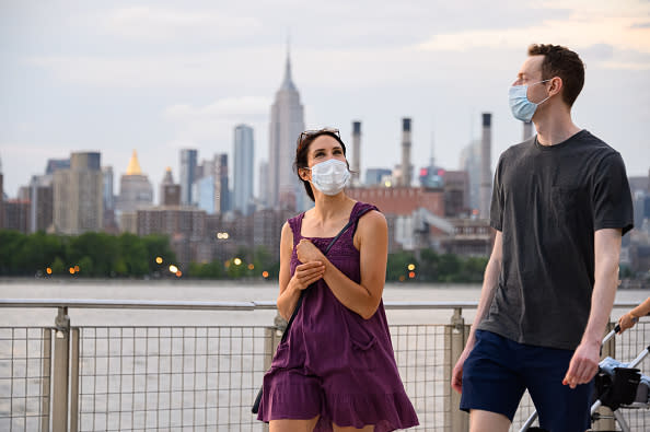 People wear protective face masks in Domino Park in Williamsburg, New York City.