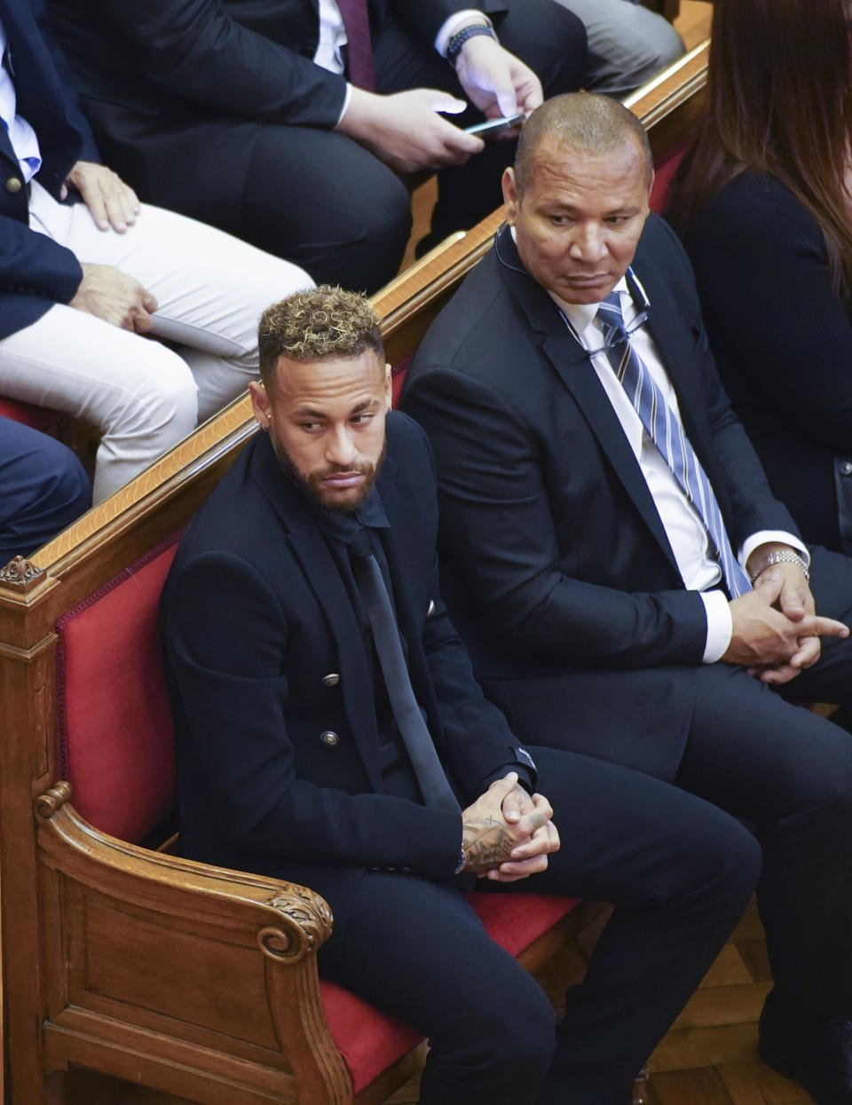 Former FC Barcelona player Neymar who now plays for Paris Saint-Germain, left, sits with his father, Neymar Da Silva Santos in court in Barcelona, Spain, Monday Oct. 17, 2022. Neymar is in court to face a trial over alleged irregularities involving his transfer to Barcelona in 2013. Neymar's parents, former Barcelona president Sandro Rosell and representatives for both the Spanish club and Brazilian team Santos are also in court after a complaint brought by Brazilian investment group DIS regarding the amount of the player's transfer. All defendants have denied wrongdoing. (AP Photo/Joan Mateu Parra)