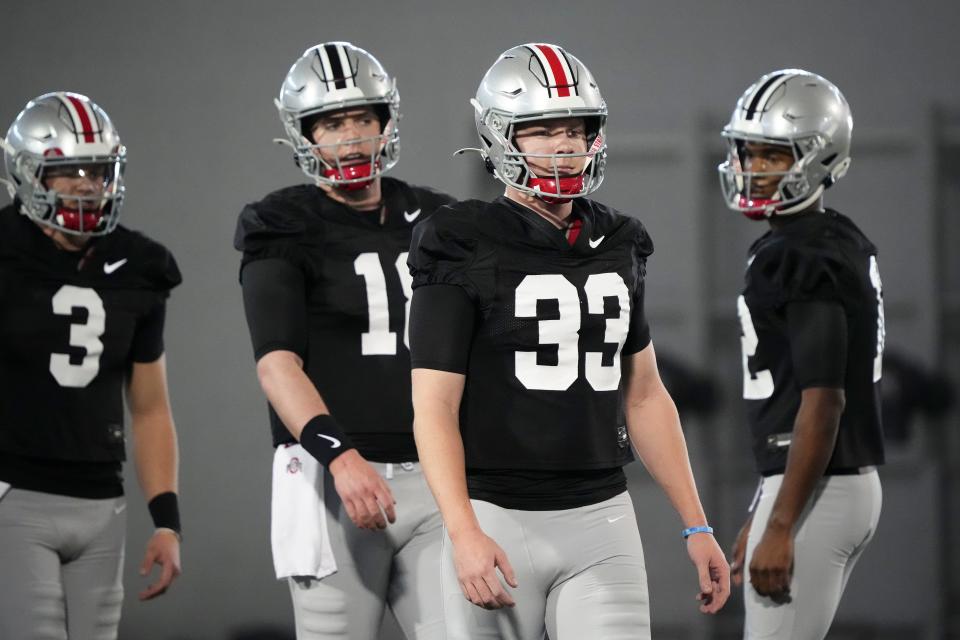 Mar 5, 2024; Columbus, OH, USA; Ohio State Buckeyes quarterback Devin Brown (33) lines up ahead of quarterbacks Air Noland (12), Will Howard (18) and Lincoln Kienholz (3) during the first spring practice at the Woody Hayes Athletic Center.