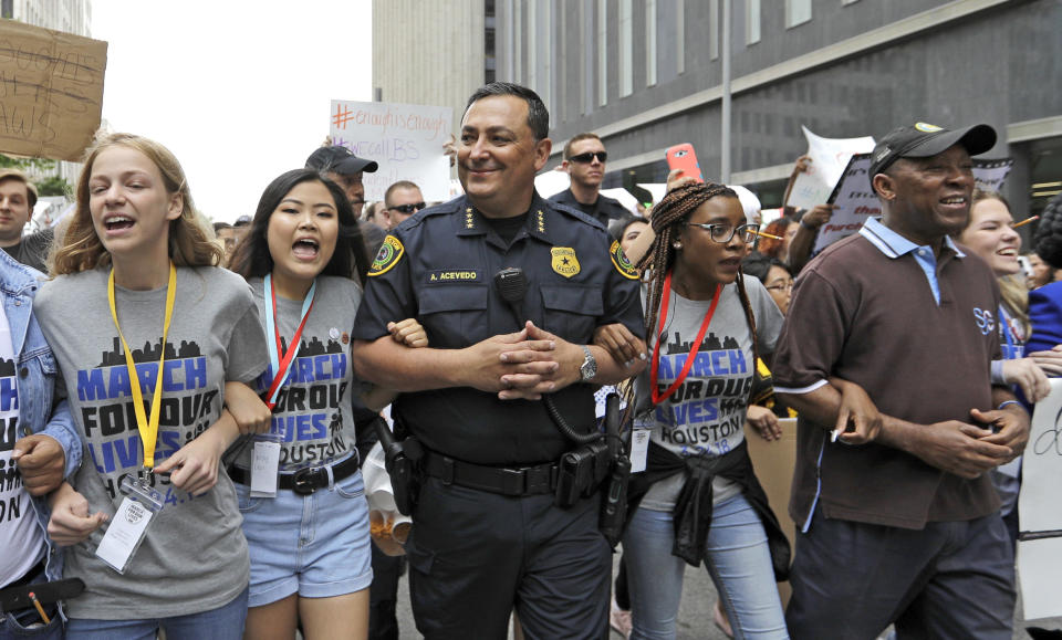 <p>Houston Police Chief Art Acevedo, center, and Houston Mayor Sylvester Turner, far right, join demonstrators during a March for Our Lives in Houston, Texas. (AP Photo/David J. Phillip) </p>