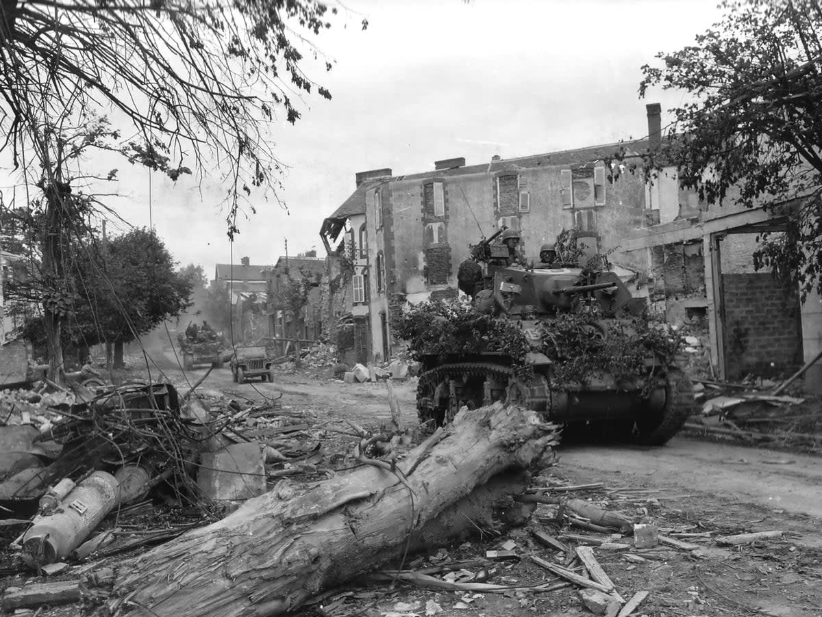 US tanks pass through the wrecked streets of the Normandy town of Coutances during Operation Cobra (US National Archives)