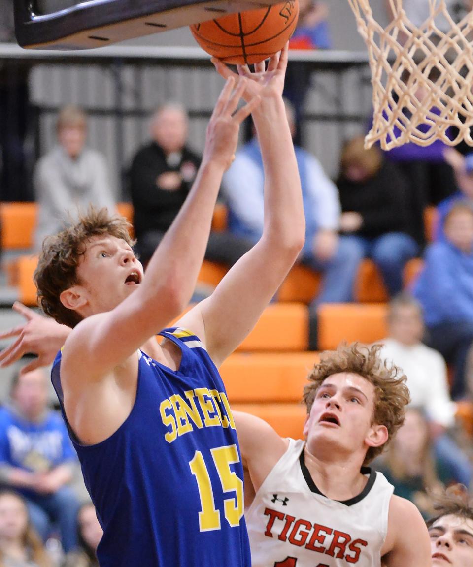 Seneca senior Evan Moffett, left, scores in the second half near Fairview sophommore Vinny Campoli during a District 10 Class 3A consolation game at the Joann Mullen Gymnasium, Hagerty Family Events Center, in Erie on Friday.