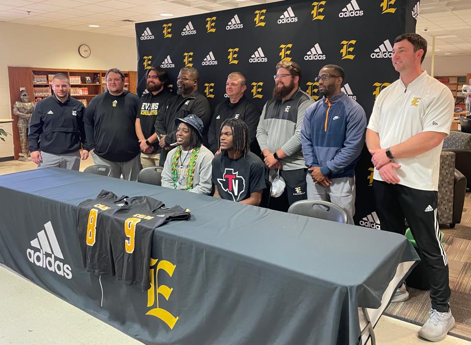 Evans seniors Jacob Jackson (left, Charleston Southern) and Rayshaun King (Trinity Valley Community College) sign national letters of intent to attend college for football.