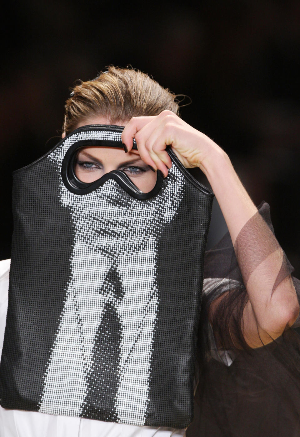 A model holds a bag with Lagerfeld's face on it during the Karl Lagerfeld spring/summer 2009 ready-to-wear collection show in Paris, on Oct. 1, 2008.&nbsp;