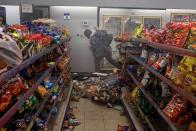 <p>A man inside a convenience store across the street from Minneapolis Police Department’s Fifth Precinct building. </p>