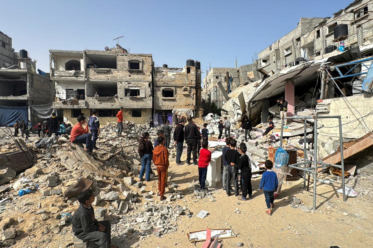 <span>Palestinians inspect the site of an Israeli strike in Rafah. Mohammed Almassri’s wife and children are due to be evacuated from the city this weekend.</span><span>Photograph: Bassam Masoud/Reuters</span>