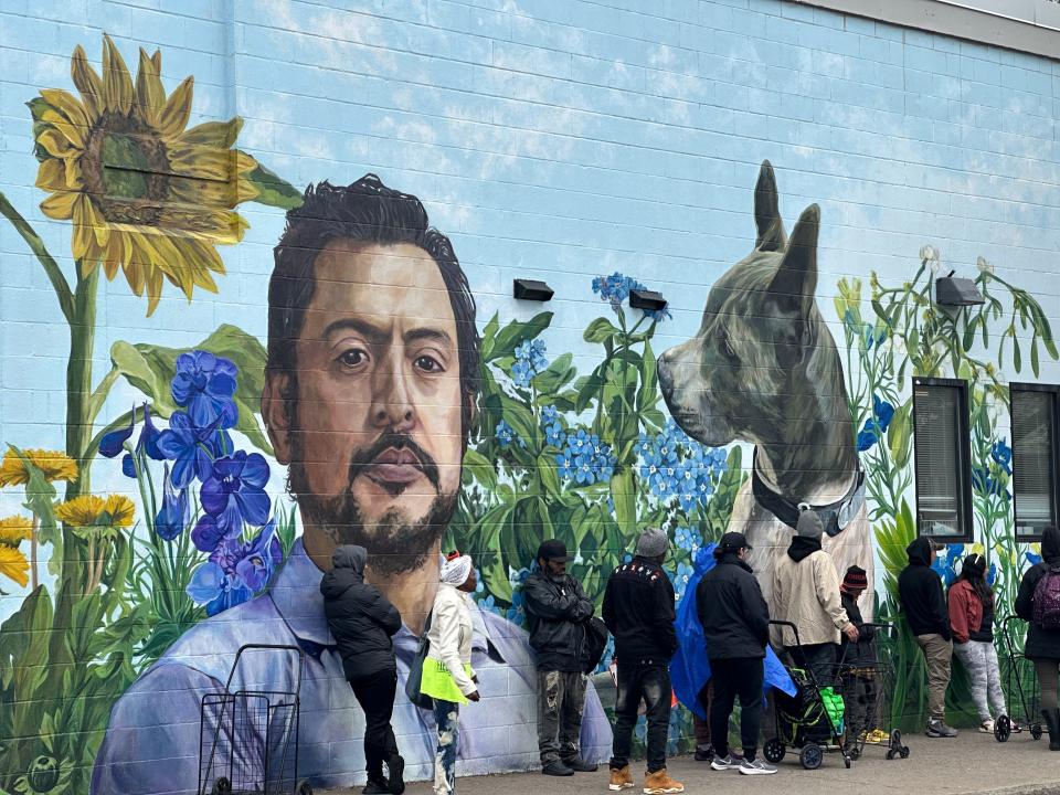 The new mural on the side of the Lincoln Branch Library at 851 Joseph Avenue by artist Chloe Smith is a memorial tribute to Edgar SantaCruz, a beloved community member who was struck and killed, along with his dog, by a hit-and-run driver in December 2022.