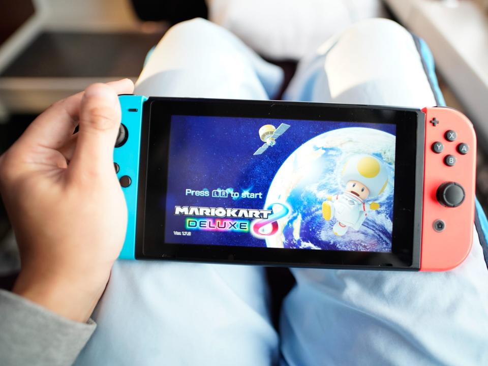 The author plays a Nintendo Switch on the train