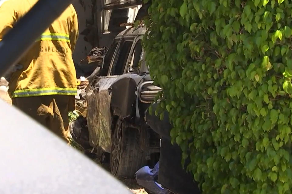 A firefighter works near the car that is believed to belong to Anne Heche after an accident in Mar Vista, California, on Friday. (KNBC)