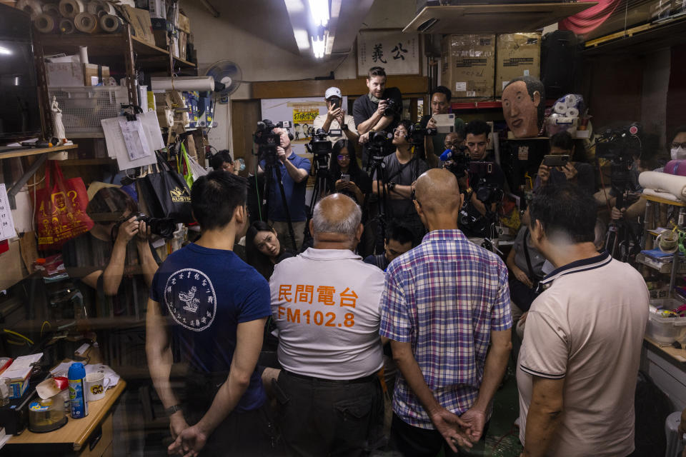 "The Bull" Tsang Kin-shing, center, founder of Hong Kong's pro-democracy Citizens' Radio station, along with radio's guests, speaks to the press prior to the radio's last broadcast in Hong Kong, Friday, June 30, 2023. (AP Photo/Louise Delmotte)