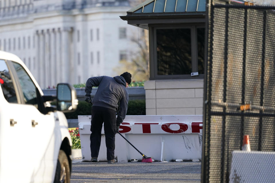 Authorities clean scene after a man rammed a car into two officers at the barricade on Capitol Hill in Washington, Friday, April 2, 2021. (AP Photo/Alex Brandon)