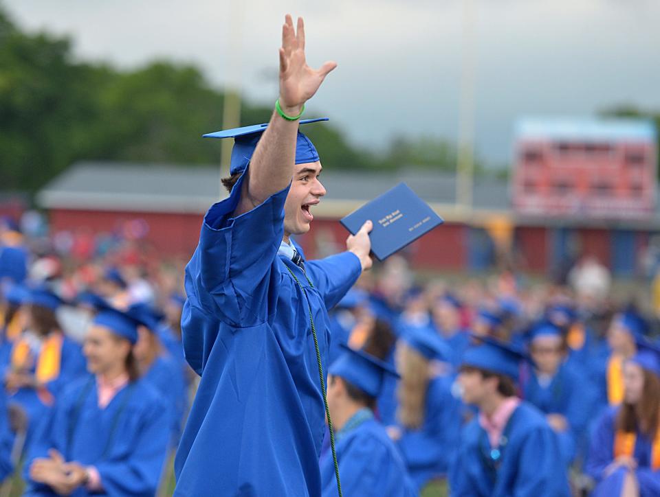 Natick High School graduate Max Jeremic celebrates after receiving his diploma during Natick High School Graduation at Memorial Field, June 3, 2022.