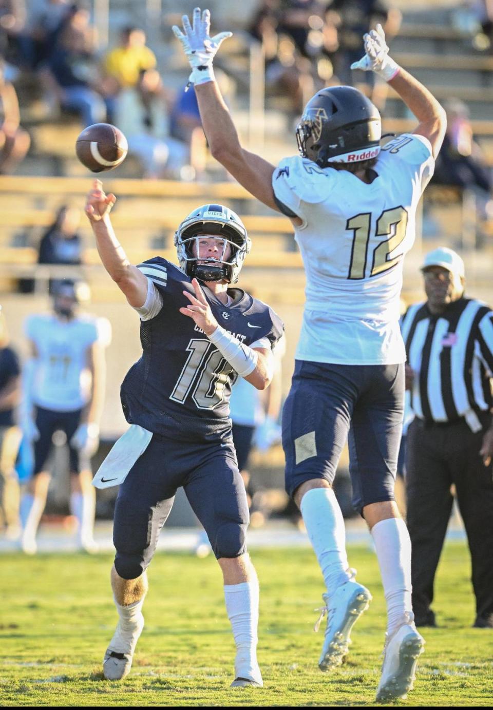 Clovis East quarterback Ty Miller, left, throws against the defense of Foothill’s Cade Nielson during their game at Lamonica Stadium on Friday, Aug. 18, 2023.