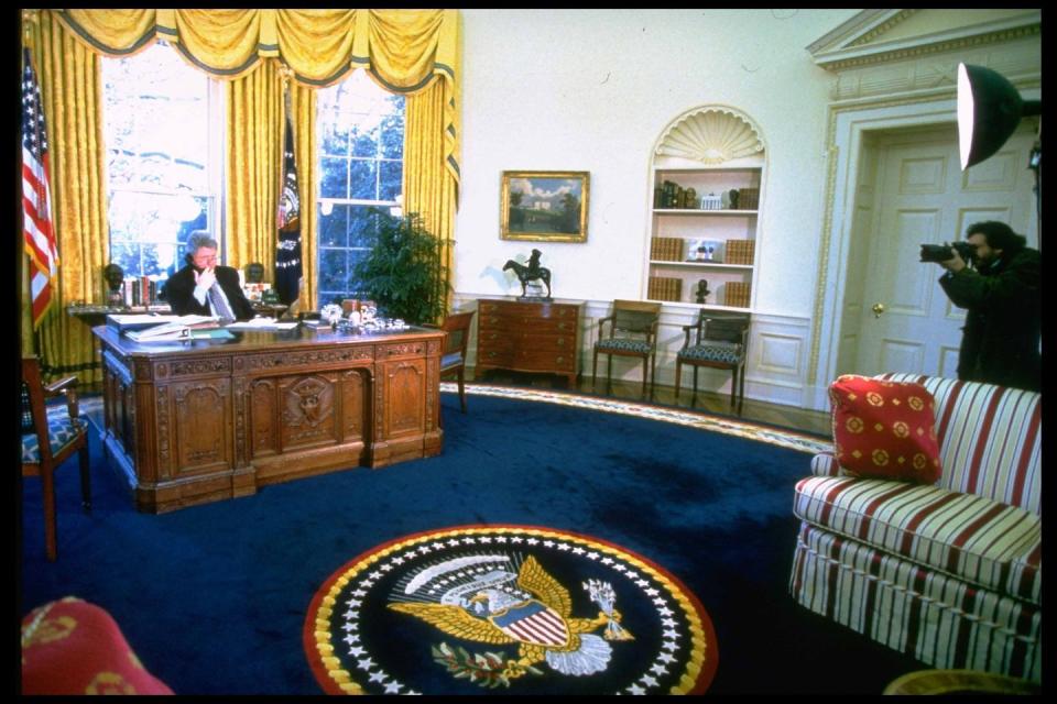 <p>President Bill Clinton takes a call in the Oval Office.</p>