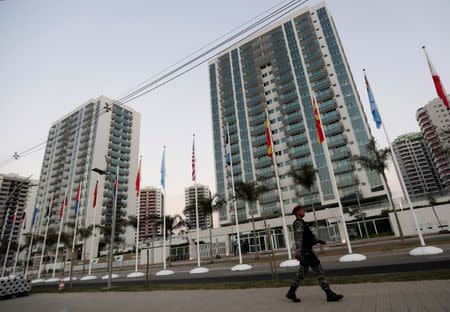 A policeman walks in front of athletes' accommodation during a guided tour for journalists to the 2016 Rio Olympics Village in Rio de Janeiro, Brazil, July 23, 2016. REUTERS/Ricardo Moraes