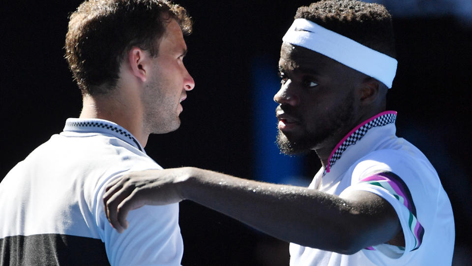 Frances Tiafoe and Grigor Dimitrov embrace. (Photo by PAUL CROCK/AFP/Getty Images)