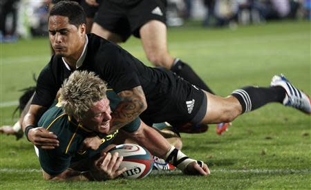 South Africa's captain Jean de Villiers scores a try as he is challenged by New Zealand's All Blacks Aaron Smith (top) during the final round of the Rugby Championship at Ellis Park stadium in Johannesburg,October 5, 2013. REUTERS/Siphiwe Sibeko