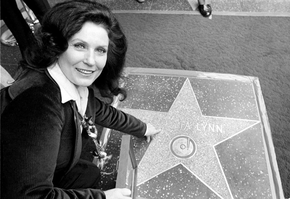 Country music singer Loretta Lynn points to her Hollywood Walk of Fame star during induction ceremonies in Hollywood, Calif., on Feb. 8, 1978. Lynn, the Kentucky coal miner’s daughter who became a pillar of country music, died Tuesday at her home in Hurricane Mills, Tenn. She was 90. (AP Photo/File)